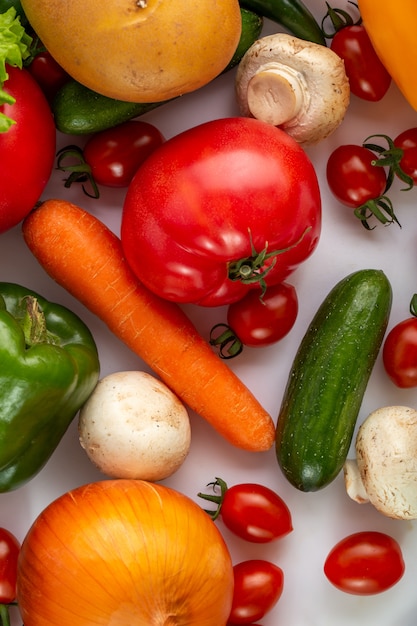 Ripe vegetables flat lays of salad vegetables such as carrott and cherry tomatoes on white floor