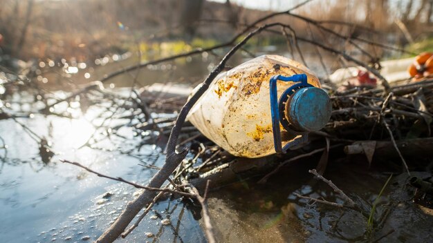 River coast with a lot of scattered plastic bottles