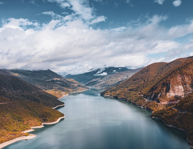 Free Photo river going through the hills under the breathtaking cloudy sky