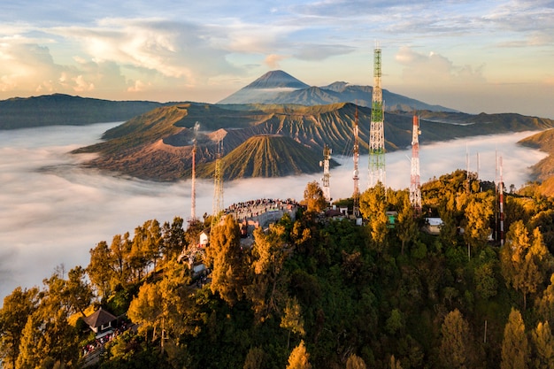 Free Photo river landscape surrounded by a forest and antennas