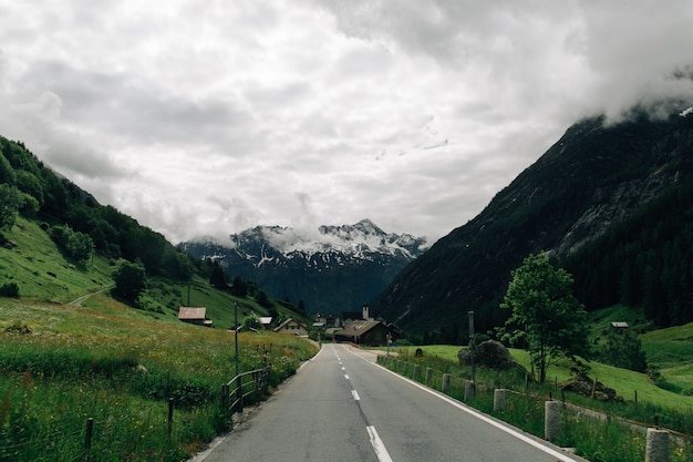 Free Photo road in swiss alps mountains in summer cloudy weather