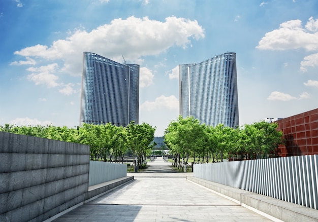 Free photo road with trees into two symmetrical buildings