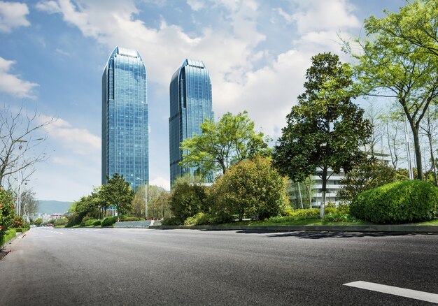 Road with trees and skyscrapers in the distance