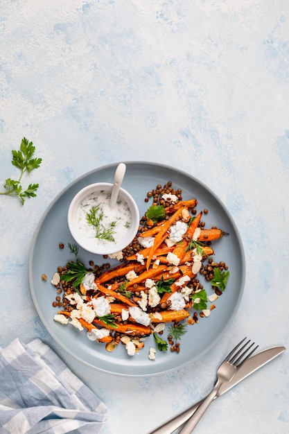 Free photo roasted carrot lentil salad with feta yogurt and dill