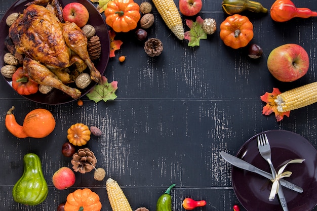 Roasted chicken near vegetables, fruits and plate 