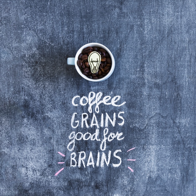 Free photo roasted coffee beans mug with text over the chalkboard