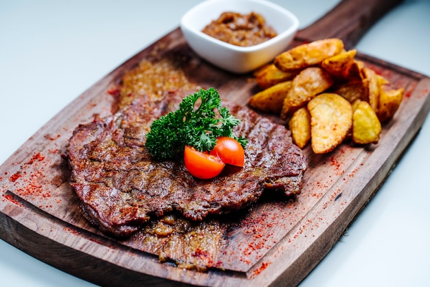 roasted meat chop with side fried potatoes