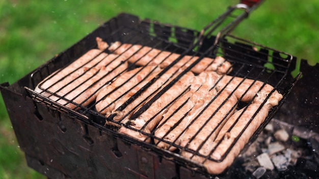 Free photo roasting meat on the grill in the nature