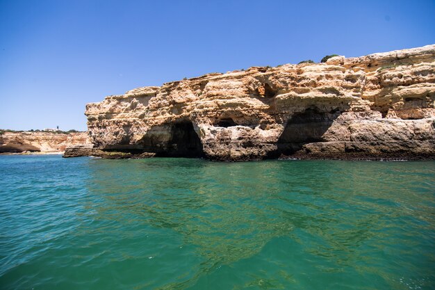 Rocks, cliffs and ocean landscape at coast in AAlgarve, Portugal view from boat