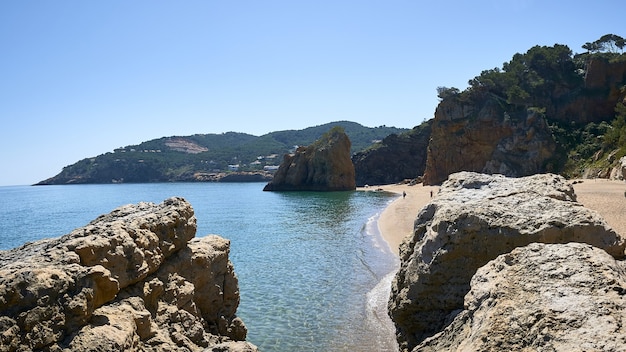 Rocks on the shore of the sea at the Playa Illa Roja public beach in Spain