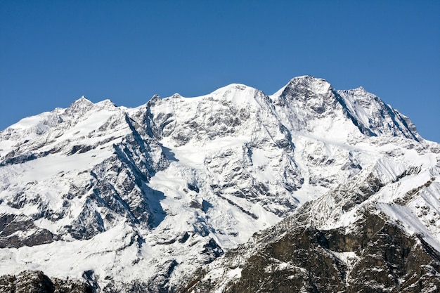 Rocky mountain covered in the sea under the sunlight and a blue sky at daytime