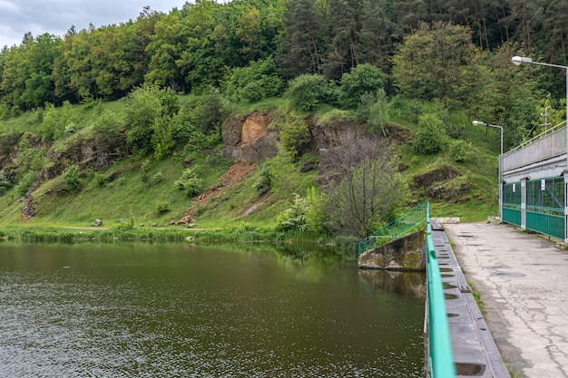 Rocky mountains covered with potion near the bridge over the river