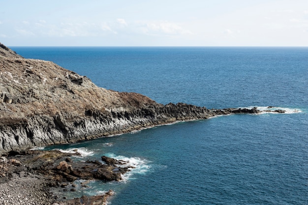 Free Photo rocky ocean littoral with clear sky