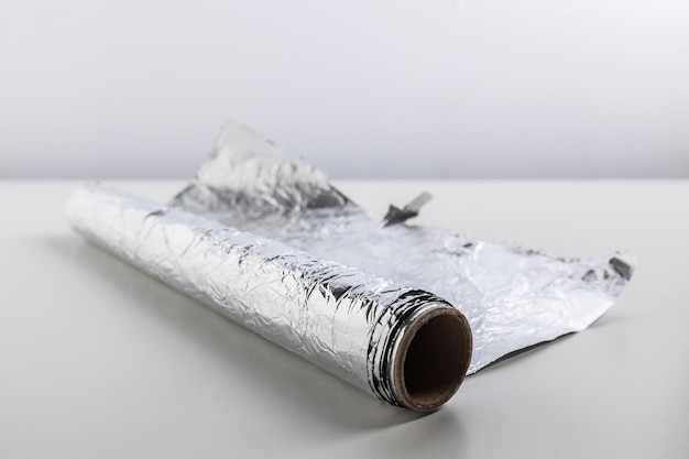 Roll of aluminum foil isolated on white background