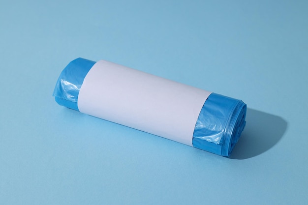 Free Photo roll of garbage bag on blue background