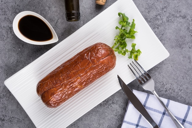 Roll of meat in a plate