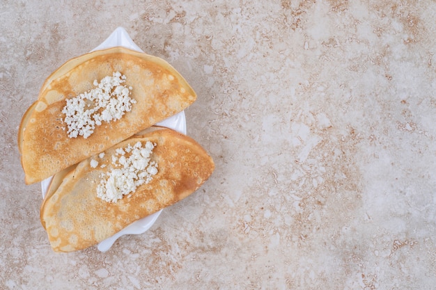 Roll pancakes with cottage cheese and milk