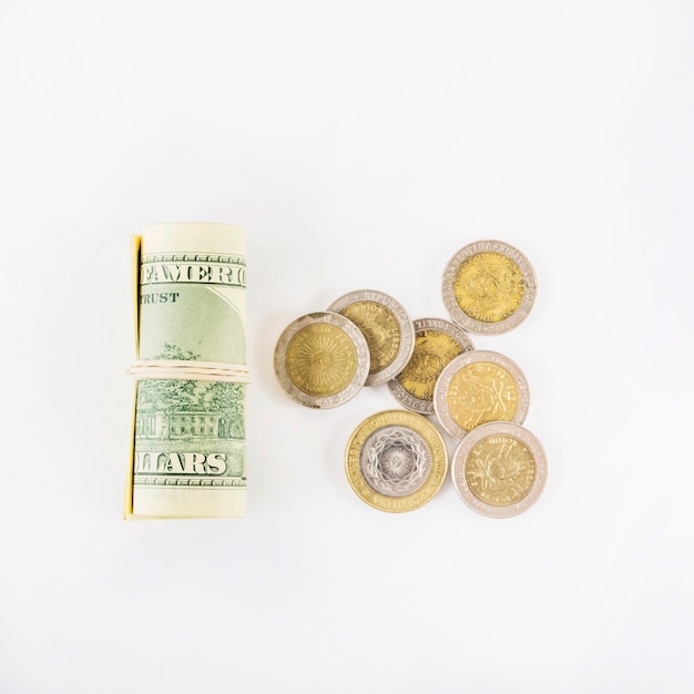 Free photo rolled dollars and coins on table