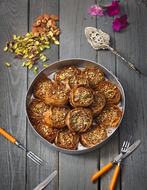 Free Photo rolls made with pumpkin seeds and almonds in a metal pot on a wooden surface