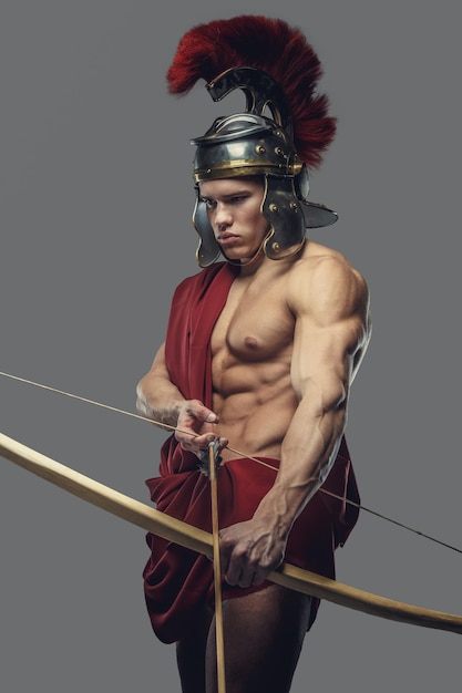 Roman warrior with bow isolated on a grey background.