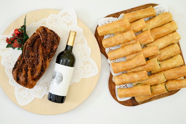 Romanian Easter Bread Cozonac with wine on the side A wooden board full of Moldovian Romanian pies