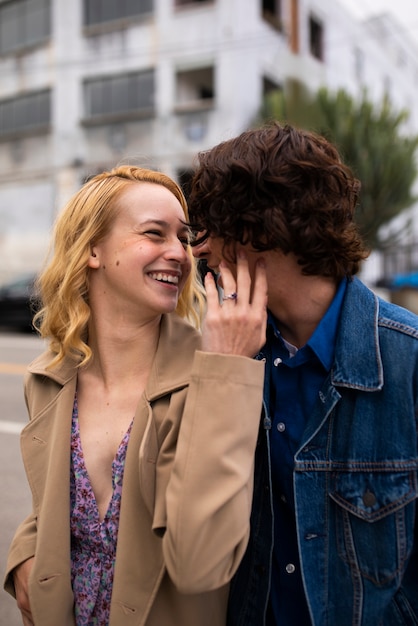 Free Photo romantic couple in the city with engagement ring after proposal