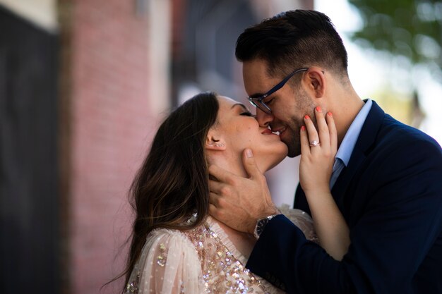 Romantic couple kissing in the city after engagement