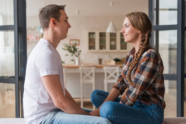 Romantic couple in love sitting together holding hands