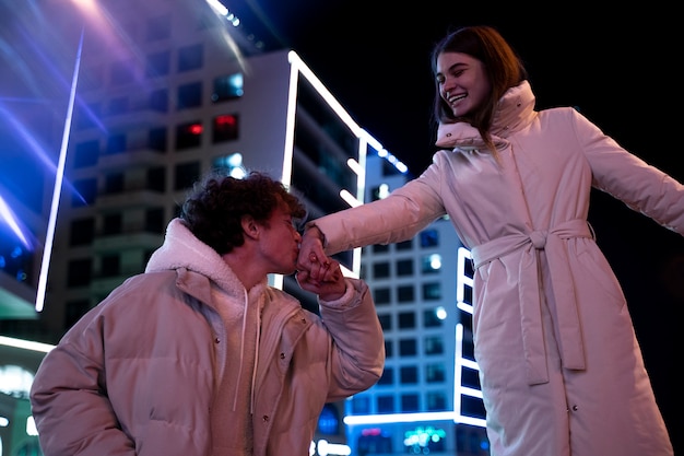 Free Photo romantic couple at night enjoying the city life