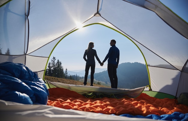 Free photo romantic couple resting in campsite at summer mountains