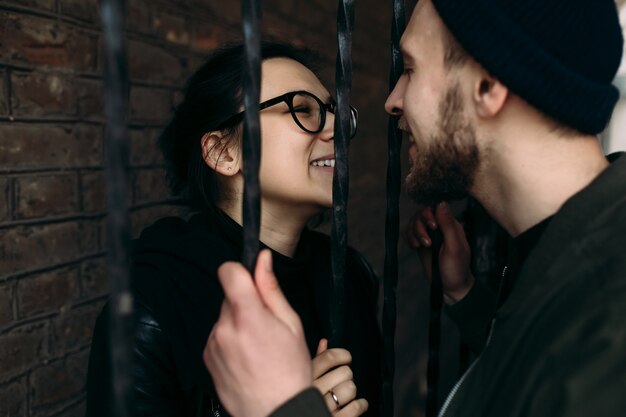 Romantic couple separated by a fence