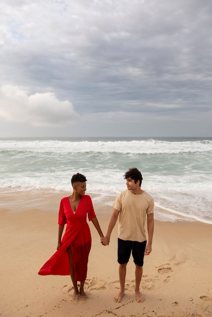 Romantic couple showing affection on the beach near the ocean