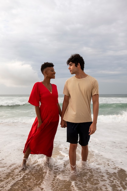 Romantic couple showing affection on the beach near the ocean