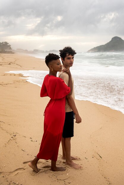 Romantic couple showing affection on the beach near the ocean