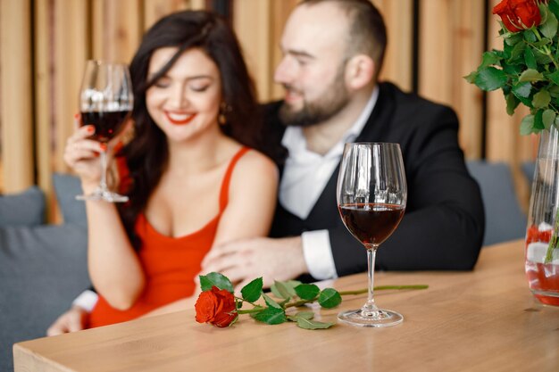 Romantic couple sitting in restaurant on a date and drinking wine