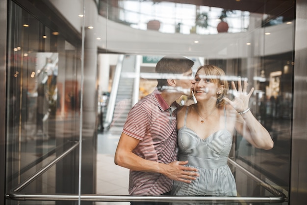 Free Photo romantic man kissing his girlfriend in an elevator