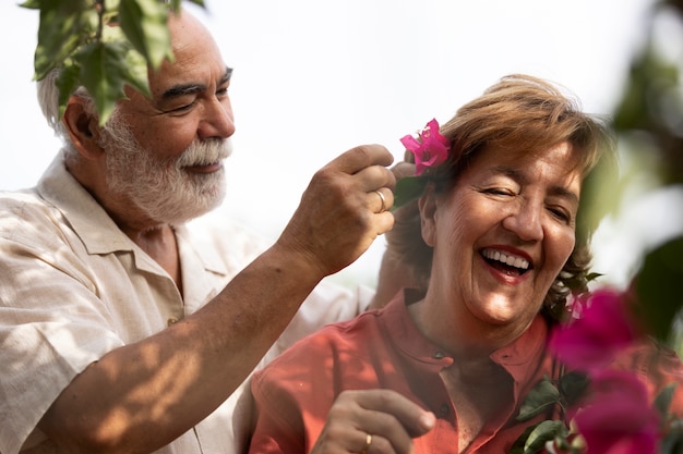 Romantic older couple at their countryside home with flowers