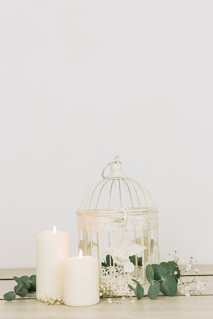 Free photo romantic ornaments with candles and cage