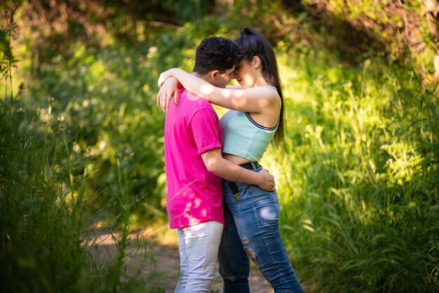 Romantic shot of a couple hugging each other intimately in the middle of a forest