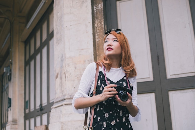 Free Photo romantic woman with camera on street