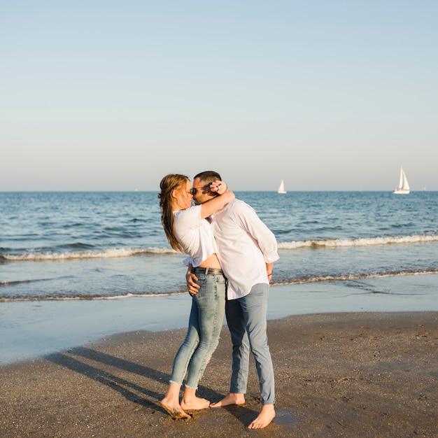 Romantic young couple enjoying summer holidays on beach