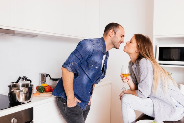 Romantic young couple kissing in the kitchen