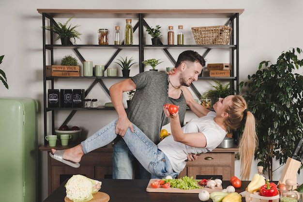 Romantic young couple standing behind the kitchen counter