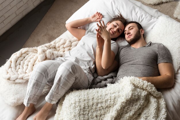 Romantic young couple together in bed