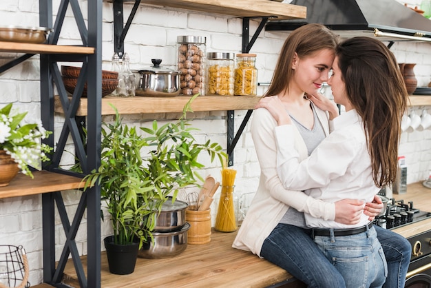 Romantic young lesbian couple in the kitchen