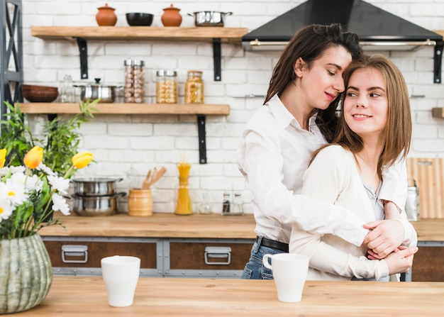 Free Photo romantic young lesbian couple loving in the kitchen