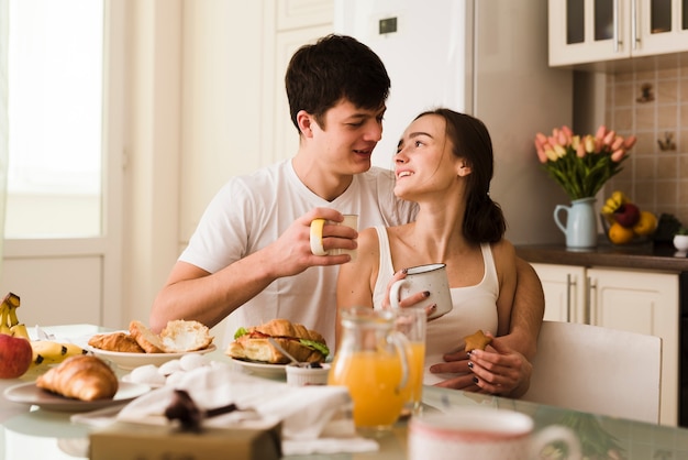 Romantic young lovers having breakfast together