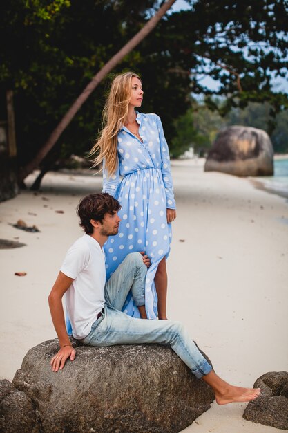 Romantic young stylish hipster couple in love on tropical beach during vacation