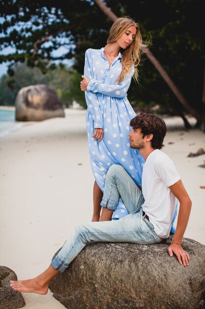 Romantic young stylish hipster couple in love on tropical beach during vacation