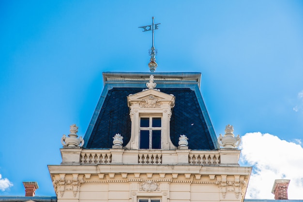 Roof of old building in front of blue sky in day time